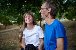 Joyful Outside Moment of Two Friends Laughing Together in Nature photo