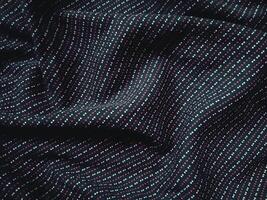 a close up of a black and blue striped fabric photo