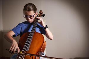Young Musician Practicing The Cello at Home with Dedicated Focus photo