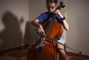 Young Musician Practicing the Cello in a Peaceful Indoor Setting photo