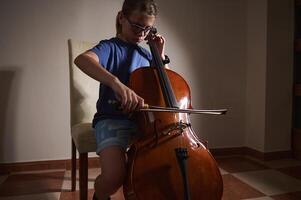 Child Practicing Cello at Home in Quiet Room photo