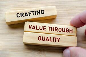Crafting value through quality text on wooden blocks represents the foundation of excellence and dedication in every detail photo