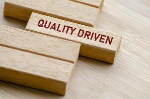Quality Driven text on wooden blocks. Business and Quality control concept photo