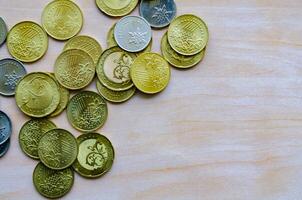 Piled coins on desk surface with customizable space for text or ideas photo
