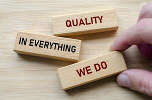 Quality in everything we do message on wooden blocks highlights a commitment to delivering consistent excellence photo