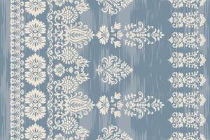 Seamless ikat floral embroidery damask pattern with ethnic textile blue abstract background. vector
