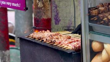 Grilled pork skewers on a Hanoi street video
