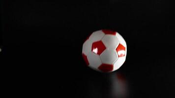 Soccer ball bouncing on a dark surface video