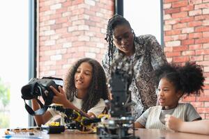 Teacher Guiding Girls in Robotics and VR Class, Young Students Exploring Technology with Virtual Reality and Robotics, STEM Education Diverse Girls Learning About Engineering and Innovation photo