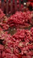 Close-up of ground beef being cooked with a spatula in a pan. Bright lighting highlights texture and color video