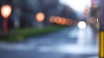 Out-of-focus lights along a street at dusk video