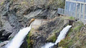 Water rushes through a hydroelectric station in Queenstown, New Zealand. Captured with steady lighting and dynamic water movement video