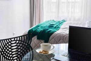 A Cozy and Inviting Workspace with a Warm Cup of Coffee and Soft Blanket in a Bright Room photo