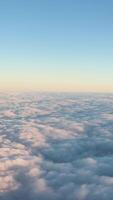 A serene aerial view of fluffy clouds under a clear blue sky, captured during a flight over Auckland, New Zealand video