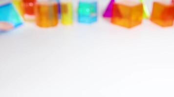 Hands manipulate colorful 3D geometric shapes on a white surface, demonstrating educational engagement with prisms and pyramids video