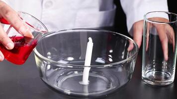 Pouring liquid into bowl with candle video