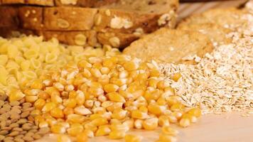 A variety of grains and pasta are artfully arranged, highlighting textures and colors under warm lighting video