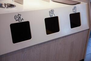Indoor Trash and Recycling Station. Garbage sorting. Plastic garbage containers. Recycle waste Bins photo