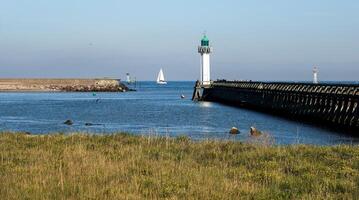 Overview of the pier, the lighthouse and the mouth of the port of Deauville photo