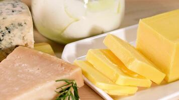Various cheeses and dairy items on black background video