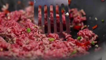Close-up of beef stir fry preparation with vegetables in a pan. Vibrant colors and dynamic cooking action video