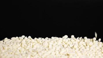 White chocolate chips cascade onto a pile video