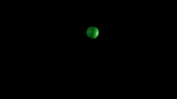 Green ball bouncing in a dark background video