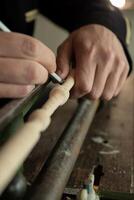 The master grinds a pattern on wood photo