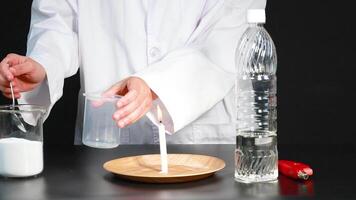 A science experiment demonstrates a chemical reaction using baking soda and vinegar to extinguish a candle flame video