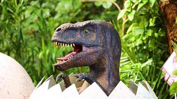 A dinosaur animatronic hatches from an egg in a vibrant, green environment with dynamic lighting and playful mood video