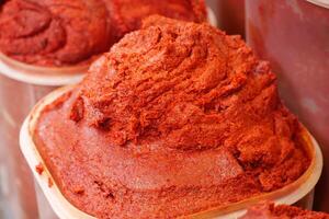 Bright red chili paste displayed at a local market stall photo