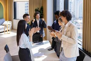Team of happy diversity business people agreement on deal over strategic strategy project on investment real estate with recognition and applause from other colleague for partnership photo