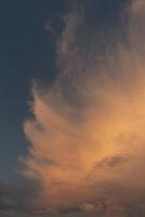 beautiful picture of clouds, feathery clouds in the light of the setting sun, fluffy cloud against the blue sky. photo