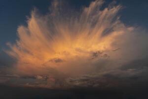 beautiful picture of clouds feathery clouds in the light of the setting sun, fluffy cloud against the blue sky photo
