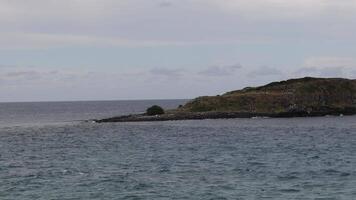 Static ocean view with small island and waves video