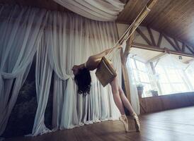 Romantic picture of a ballerina, a ballerina in pointe shoes, swinging on a swing, a ballerina in a leopard photo