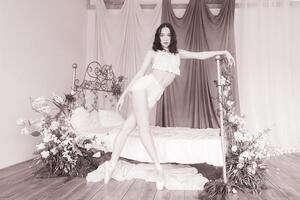 Beautiful romantic ballerina, ballerina in pointe shoes and pyjamas stands by the bed, ballerina in leopard. photo