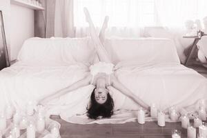 Beautiful romantic ballerina, ballerina in pointe shoes and pyjamas lying on a sofa surrounded by candles, ballerina in leopard. photo