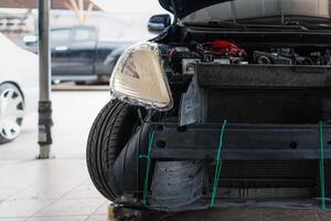A car with its engine and front end on the ground photo