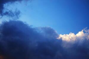 Silhouette cloud in sunset and golden sunlight Illuminating on blue sky in dusk and twilight in evening. Copy space photo