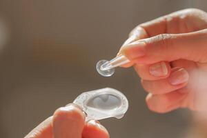 Applying Soft Contact Lens from Package for Vision Correction and Refractive Error Solution Close Up photo