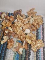 A detailed close-up of the walnut kernel reveals its interior beauty, showcasing the freshly extracted, nutrient-rich center and its unique texture. photo