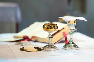 Chalice and consecrated host part for Eucharist photo