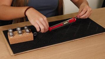 A person uses a spring scale to measure the force needed to drag a weighted block across a surface video