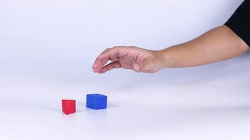 Hands manipulate red and blue geometric blocks video