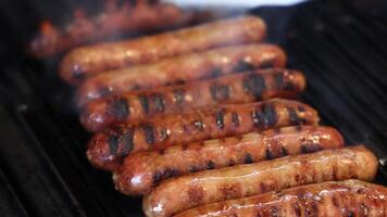 Sausages being grilled and cooked on a barbecue video