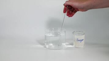 Sequential steps of sugar being stirred into water video