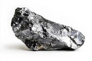 A close up view of a shiny black rock formation on a white surface with light reflections photo