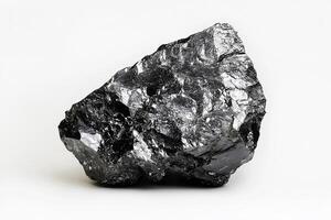 Close up shot of a shiny black coal rock sitting on a white surface in a studio setting photo