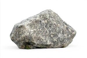 A large granite boulder with visible texture and small patch of grass at its base on white photo